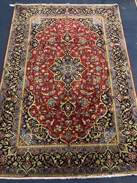 A Kashan blue and red ground carpet 200 x 138cm.